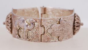 A vintage white metal bangle with camel