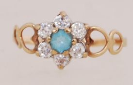 A 9ct gold cluster ring set with CZ and central blue stone. Marked 375 Optima CZ 9ct. Tests 9ct.