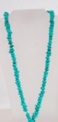 A turquoise stye stone bead necklace. Me