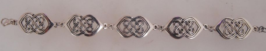 A white metal celtic link bracelet with
