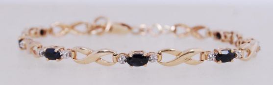 A 9ct gold sapphire and diamond bracelet with lobster claw clasp.