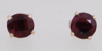 A pair of 9ct gold earrings set with dar