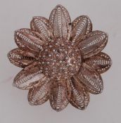 A vintage white metal filigree flower br