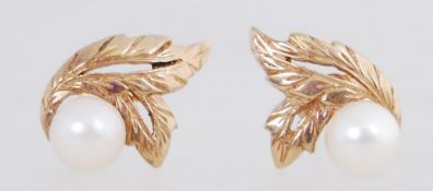 A pair of 9ct gold earrings set with pea