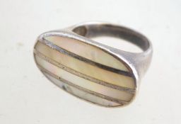 A large silver and mother of pearl ring, with a 