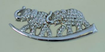 A vintage staybright elephants brooch, in silver tone metal with a loop clasp. Measuring 5.