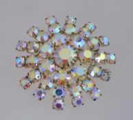 A large 1950s aurora rhinestone brooch in a gold tone metal setting with a roll over clasp,