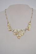 A 1970s jewelcraft necklace in gold tone metal with faux pearls and a hook clasp,