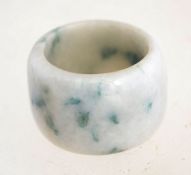 A wide jade ring.