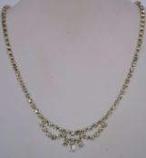 A 1950s rhinestone necklace in a silver tone metal setting with a bolt ring clasp, measuring 40.
