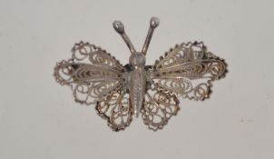 A vintage silver filigree butterfly miniature brooch with a loop clasp,