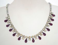 A 1950s rhinestone necklace in a silver tone metal setting with a fold over catch,