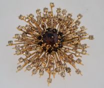 A large 1960s sunburst rhinestone brooch with the stones graduating from a dark topaz colour to