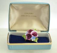 A 1960s porcelain floral brooch by Coalport, measuring 3.