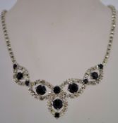 A 1980s rhinestone necklace with black and white rhinestones in a silver tone metal setting,
