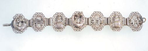 A 1920s Czech filigree chinoiserie hook fastening bracelet in silver tone metal,