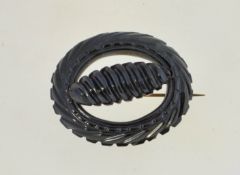 A Victorian Whitbyjet brooch, with a brass pin and a loop clasp. Measuring 4.3cms long.