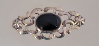 A vintage silver and black onyx brooch with a roll over clasp, it measures 5.5cms long.