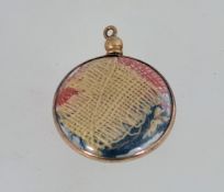 A WW1 photo pendant, containing small pieces of a union jack flag.