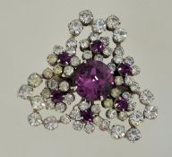 A 1950s to 1960s rhinestone brooch in a silver tone metal setting with a roll over catch,