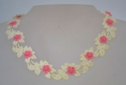 A pair of 1950s to 1960s plastic pop-bead necklaces, one in pink, one in blue.
