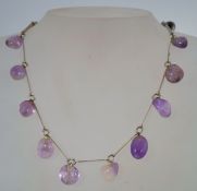 A 1960s silver tone metal and amethyst necklace with a loop clasp, measuring 41.5cms long.