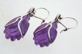 A pair of vintage silver and carved amethyst earrings, with amethyst drops on later hooks.