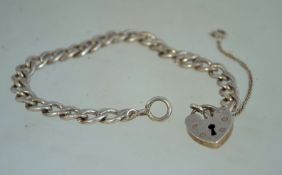 A vintage silver belcher chain bracelet with a heart padlock clasp and safety chain.
