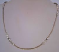 A silver mesh rope necklace with decorative rings and portugese hallmarks and a 