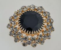 A Carque 1960s cluster brooch with grey rhinestones surrounding a large black stone,