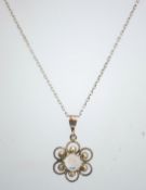 A silver and moonstone pendant on a chain,