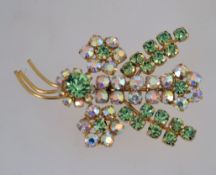 A 1950s rhinestone spray brooch with aurora and peridot colour rhinestones in a gold tone metal