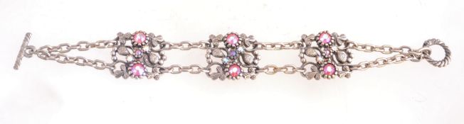 A 1960s rhinestone bracelet with floral panels set with pink aurora rhinestones,
