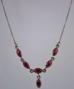 A silver and garnet necklace with sterling silver, marked 