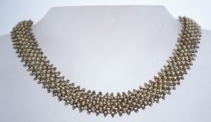 A vintage silver canetille work mesh necklace with a bolt ring clasp.
