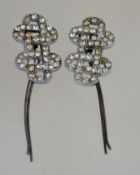 A pair of art deco hair grips, in silver tone metal with rhinestones, measuring 6cms long.