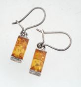 A pair of silver and amber earrings marked 