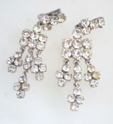 A pair of 1950s to 1960s rhinestone chandelier clip earrings in a silver tone metal setting,