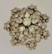 A 1950s to 1960s rhinestone cluster brooch in a silver tone setting with a rollover clasp,