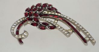 A large 1950s rhinestone brooch in a silver tone setting with a rollover clasp, measuring 7cms long.