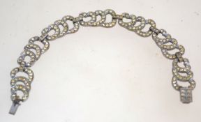 A 1930s art deco rhinestone bracelet, in silver tone metal with a box clasp, measuring 18cms long.