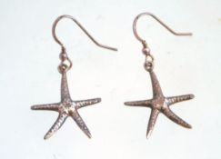 A pair of silver starfish earrings,