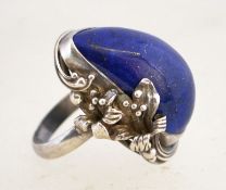 A large vintage silver and lapis lazuli ring with a lily design setting, marked 