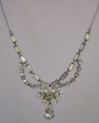 A 1950s rhinestone necklace in a silver tone metal setting with a bolt ring clasp, measuring at 40.