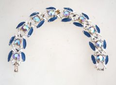 A1950s rhinestone and enamel bracelet in a silver tone metal setting with a fold over clasp,