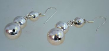 A pair of silver hoop earrings, marked 