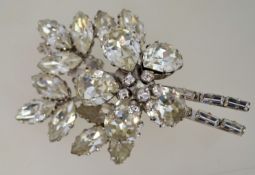 A very large 1950s rhinestone brooch in silver tone metal with a loop clasp and safety chain,