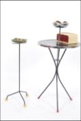 A 1950's Atomic metal work ashtray with ball finial feet together with another similar with ashtray