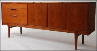 A 1970's Nathan teak sideboard dresser raised on tapered legs with a series of drawers and cupboard