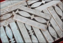 A collection of Art Nouveau ceramic tiles in two different sizes being marked to the underside with